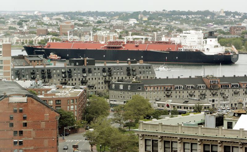 FILE PHOTO: A liquefied natural gas (LNG) tanker passes downtown Boston as it navigates though Boston Harbor in Boston