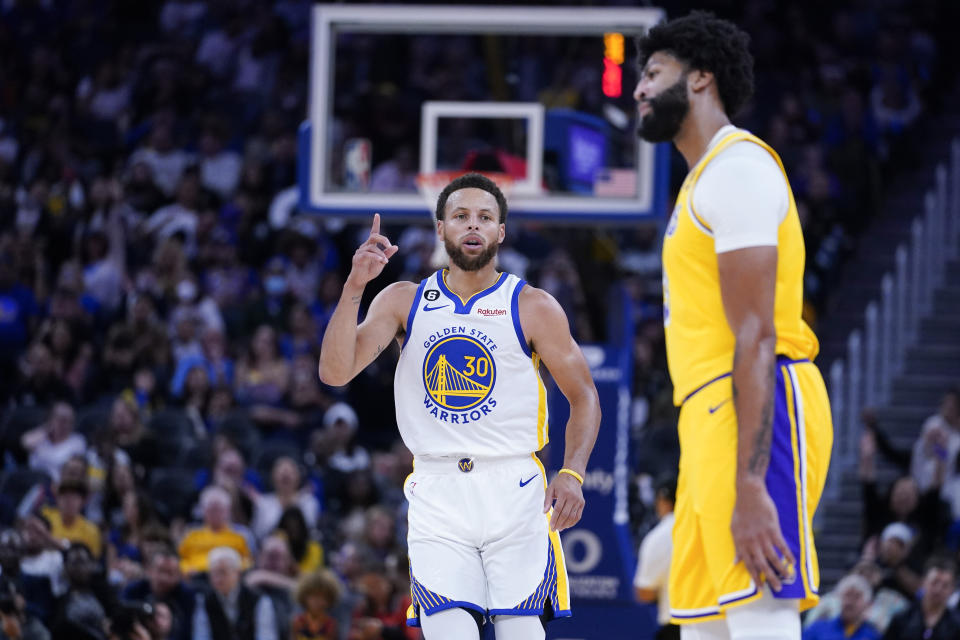 Golden State Warriors guard Stephen Curry reacts after scoring a three-pointer against the Los Angeles Lakers during the first half of a basketball game in San Francisco, Sunday, Oct. 9, 2022. (AP Photo/Godofredo A. Vásquez)