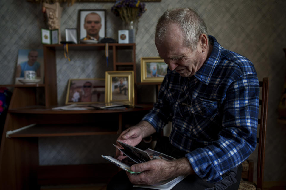 Oleksandr Turovskyi, whose 35-year old son Sviatoslav was among eight men executed in a vacant lot in the suburb of Bucha in March 2022, looks at pictures of his son at his apartment in Bucha, Ukraine, Saturday, March 30, 2024. Days after Russian forces withdrew from the area in late March, in the dramatic first weeks of the full-scale invasion, a photo taken by AP Photographer Vadim Ghirda revealed what happened to the eight men. "Parents should not bury their children. It's not fair," he said. (AP Photo/Vadim Ghirda)