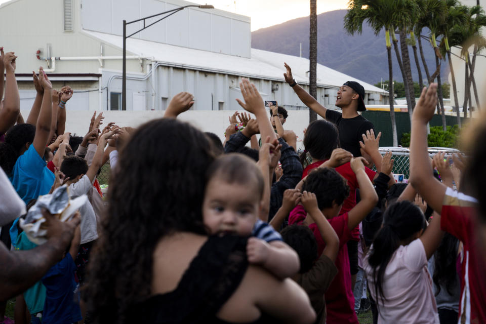 FILE - Children, mostly those who lost their homes in the Lahaina wildfire, attend a toy giveaway by Project 5000, a missionary program, at the Church of the Nazarene, Friday, Dec. 8, 2023, in Kahului, Hawaii. (AP Photo/Lindsey Wasson, File)