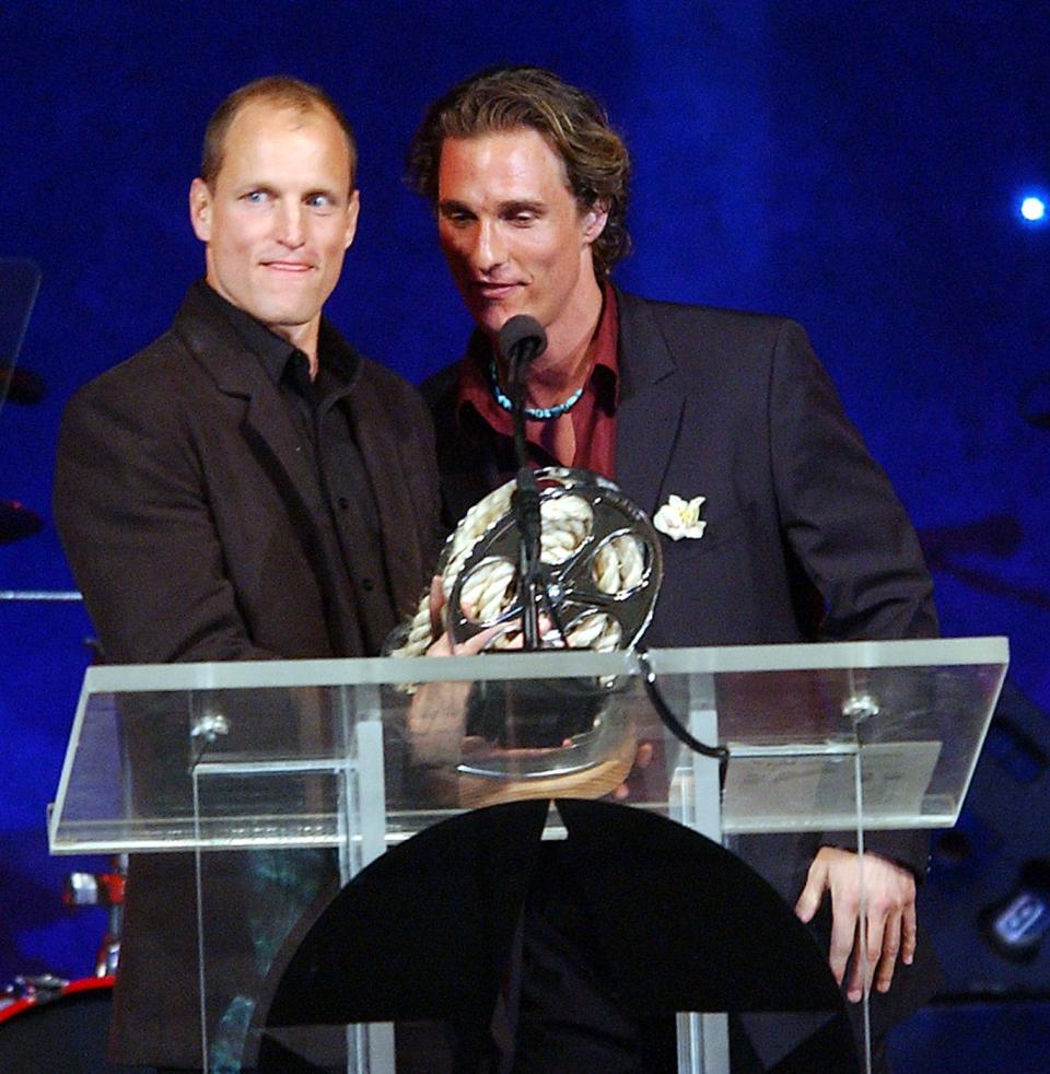 Woody Harrelson, left, receives his award for being inducted into the Texas Film Hall of Fame from Matthew McConaughey at the Texas Film Hall of Fame Awards in 2003.