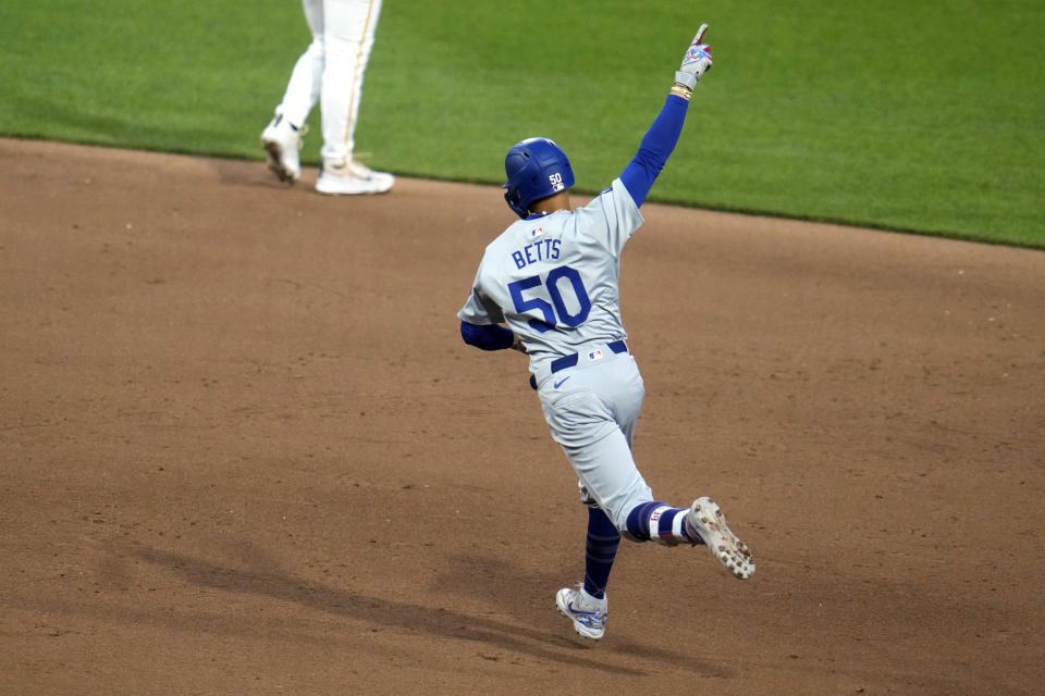 Los Angeles Dodgers' Mookie Betts celebrates as he run the bases on a three-run home run off Pittsburgh Pirates relief pitcher Ben Heller during the fifth inning of a baseball game in Pittsburgh, Thursday, June 6, 2024. (AP Photo/Gene J. Puskar)