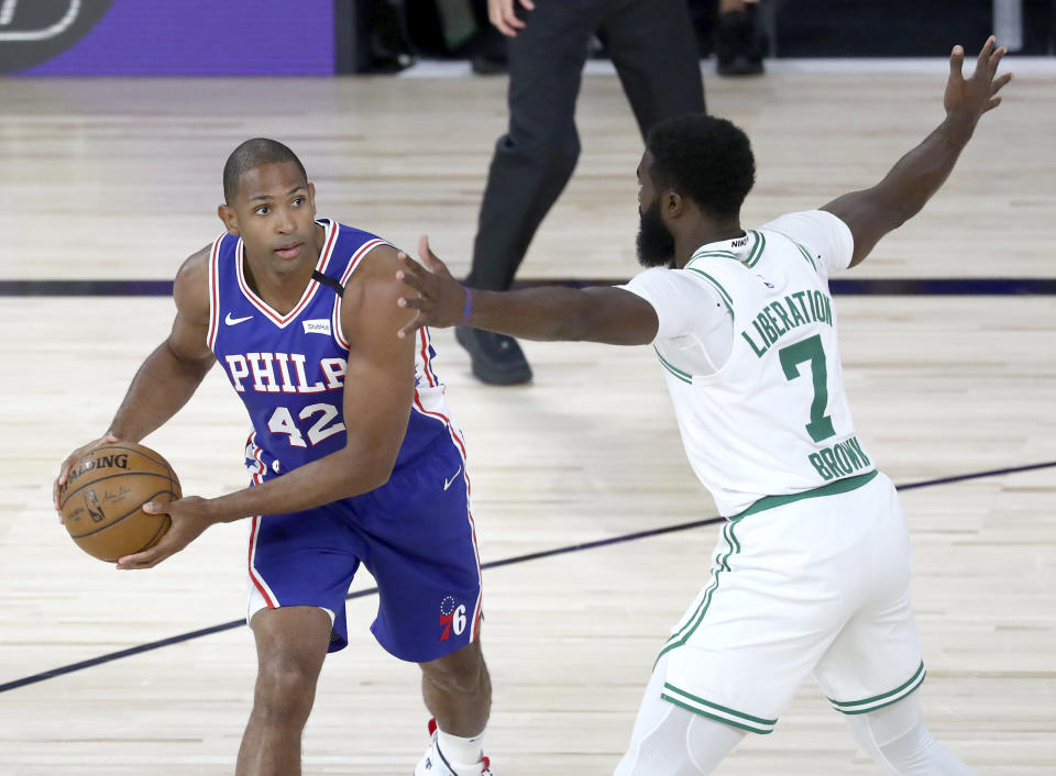 Philadelphia 76ers forward Al Horford (42) looks to pass as Boston Celtics guard Jaylen Brown (7) defends during the first quarter of Game 4 of an NBA basketball first-round playoff series, Sunday, Aug. 23, 2020, in Lake Buena Vista, Fla. (Kim Klement/Pool Photo via AP)