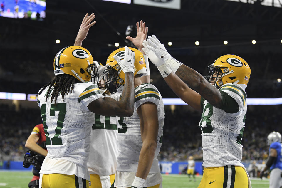 Green Bay Packers wide receiver Allen Lazard (13) is congratulated by teammates after scoring during the first half of an NFL football game against the Detroit Lions, Sunday, Jan. 9, 2022, in Detroit. (AP Photo/Lon Horwedel)