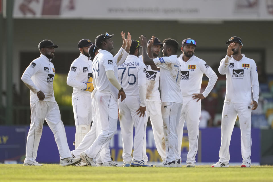 Sri Lanka's Asitha Fernando is congratulated by teammates for the wicket of Pakistan's Pakistan's Shan Masood during the day one of the second cricket test match between Sri Lanka and Pakistan in Colombo, Sri Lanka on Monday, Jul. 24. (AP Photo/Eranga Jayawardena)