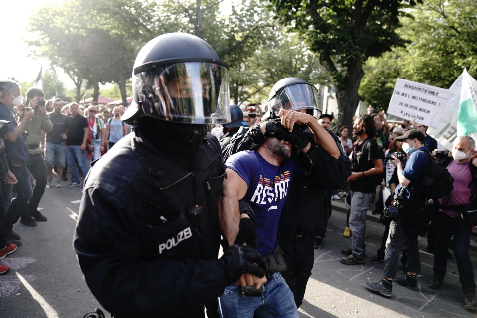 Police take a man away at the boulevard Unter den Linden during a protest against Corona measures in Berlin, Germany, Saturday, Aug. 29, 2020. (Kay Nietfeld/dpa via AP)