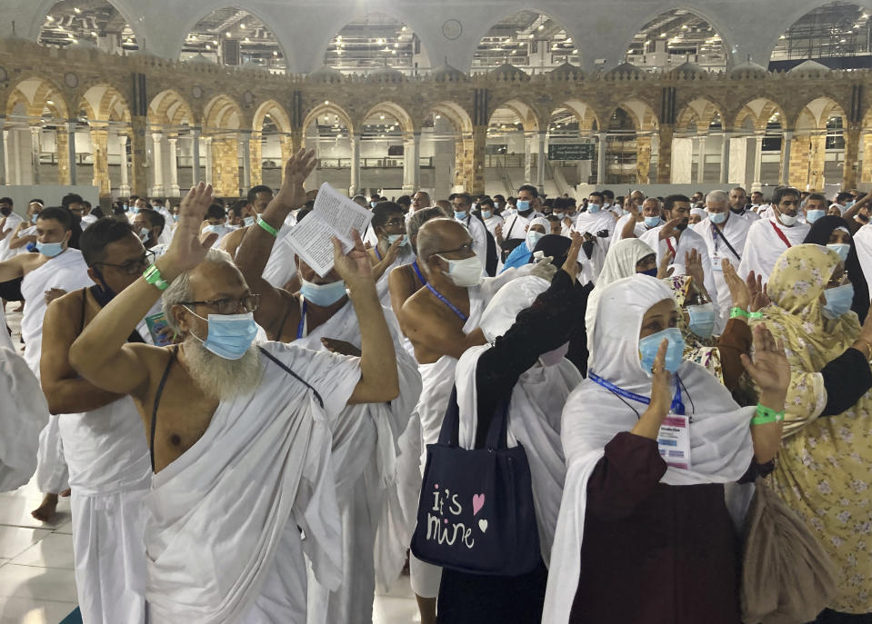 Muslim pilgrims circumambulate around the Kaaba, the cubic building at the Grand Mosque, without social distancing for the first time since the beginning of coronavirus pandemic, in the Muslim holy city of Mecca, Saudi Arabia, Sunday, Oct. 17, 2021. The Ministry of Interior announced Friday that, due to a significant nationwide decline in COVID-19 cases and the Kingdom's high vaccination rates, a number of restrictions will be relaxed starting Sunday. (AP Photo/Amr Nabil)