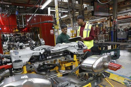 Chris Morrison (R) speaks to a worker at the Jaguar Land Rover facility in Solihull, Britain, January 30, 2017. REUTERS/Darren Staples