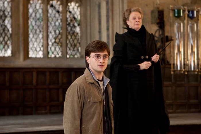 Daniel Radcliffe as Harry Potter stands in front of Maggie Smith as Professor McGonagall in a room with large windows and wooden paneling