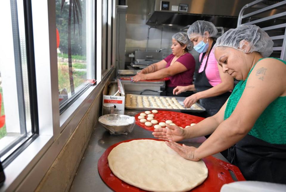 Zuly Martinez, Diana Forero and Maria Guzman prepare Sonoran-style flour tortillas at Yoli Tortilleria, a finalist in the Outstanding Bakery category for the 2023 James Beard Awards. Tammy Ljungblad/tljungblad@kcstar.com