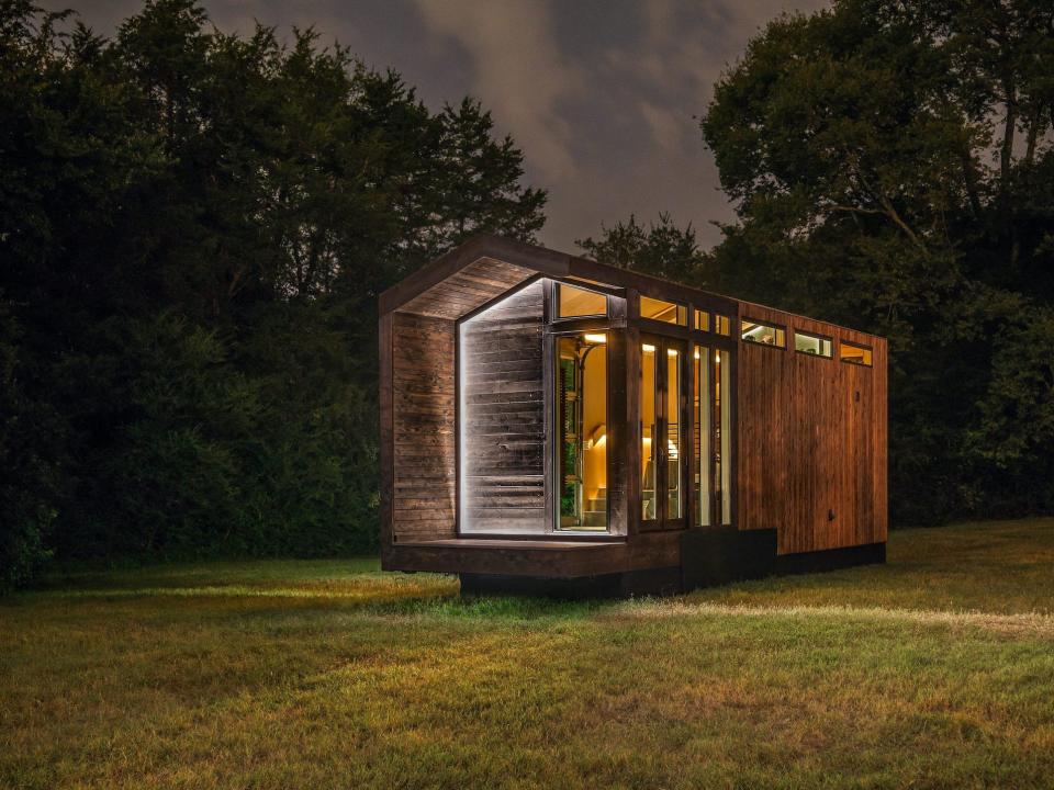 a tiny home in a field at night