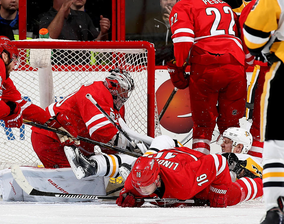 RALEIGH, NC - JANUARY 20: Cam Ward #30 of the Carolina Hurricanes collides in the crease with Patric Hornqvist #72 of the Pittsburgh Penguins as Elias Lindholm #16 goes down on the ice during an NHL game on January 20, 2017 at PNC Arena in Raleigh, North Carolina. (Photo by Gregg Forwerck/NHLI via Getty Images)