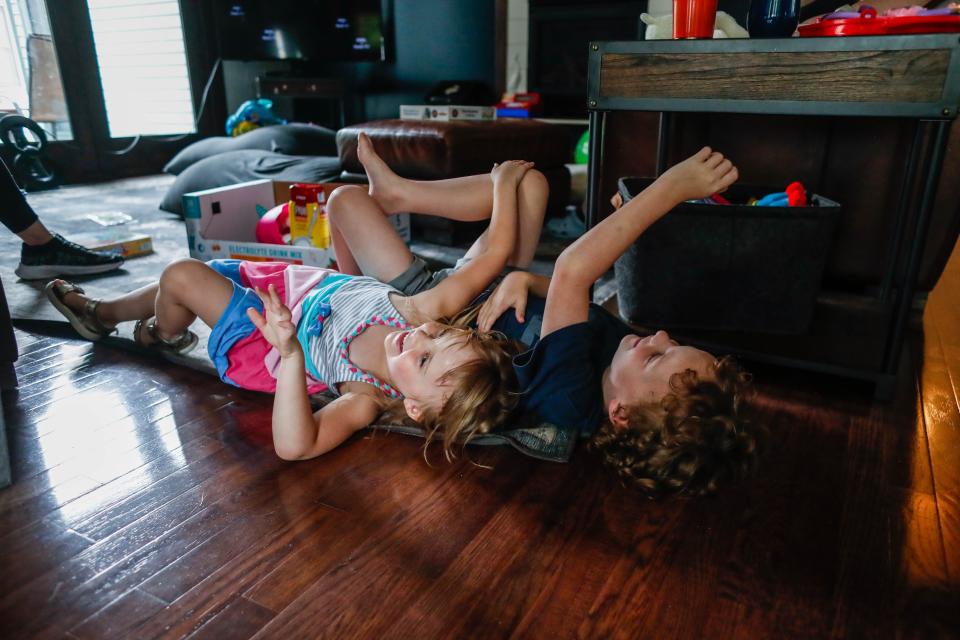 Audrey, 5, play wrestles with her brother Michael Francis, 7.