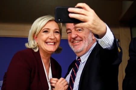 French far-right National Rally party leader Le Pen poses for a selfie with Belgium's MEP Annemans at the EU Parliament in Brussels