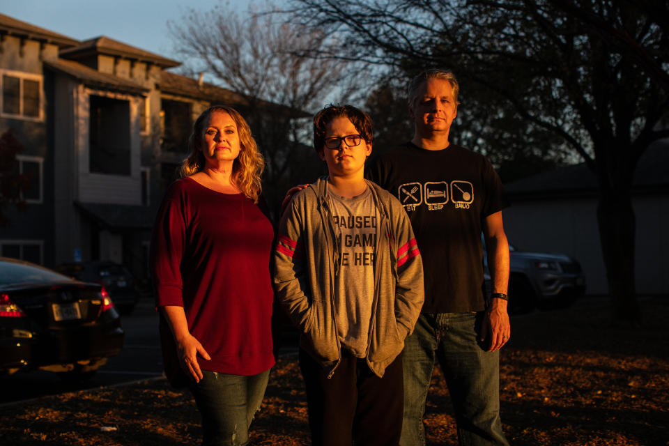 Kandis, Cooper and Rob Seaver stand for a portrait at their apartment complex in Austin, Texas, on Dec. 8, 2020.  (Photo: Tamir Kalifa for HuffPost)