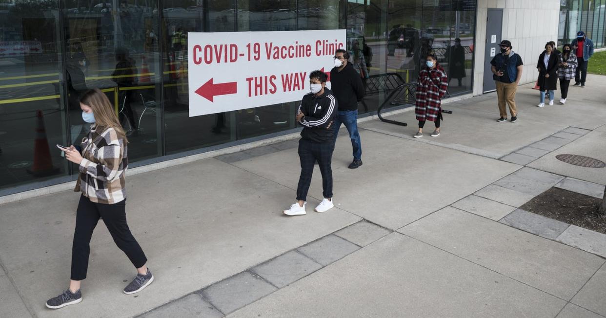 <span class="caption">People line up outside the University of Toronto Mississauga campus for a COVID-19 vaccination clinic in Mississauga, Ont., in May. </span> <span class="attribution"><span class="source">THE CANADIAN PRESS/Tijana Martin </span></span>