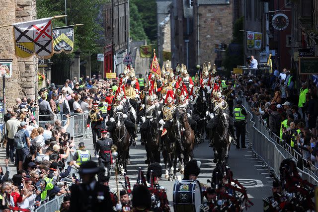 <p>Russell Cheyne - WPA Pool/Getty Images</p> Military members process at King Charles' coronation celebration in Edinburgh on July 5.