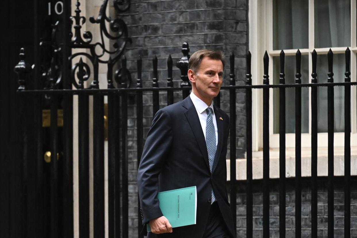 Britain's Chancellor of the Exchequer Jeremy Hunt leaves Downing Street in central London on his way to make a full budget statement in the House of Commons on November 17, 2022. - Britain is set to unveil hefty tax rises and spending cuts at the risk of worsening a cost-of-living crisis for millions in the recession-bound economy. (Photo by JUSTIN TALLIS / AFP) (Photo by JUSTIN TALLIS/AFP via Getty Images)