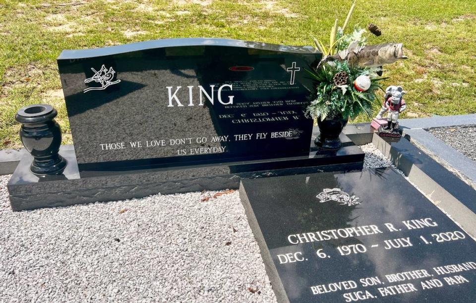 An etching of a largemouth bass graces the tombstone of Chris King’s grave at the Lizella Baptist Church Cemetery west of Macon, Ga. / Jason Vorhees/The Telegraph