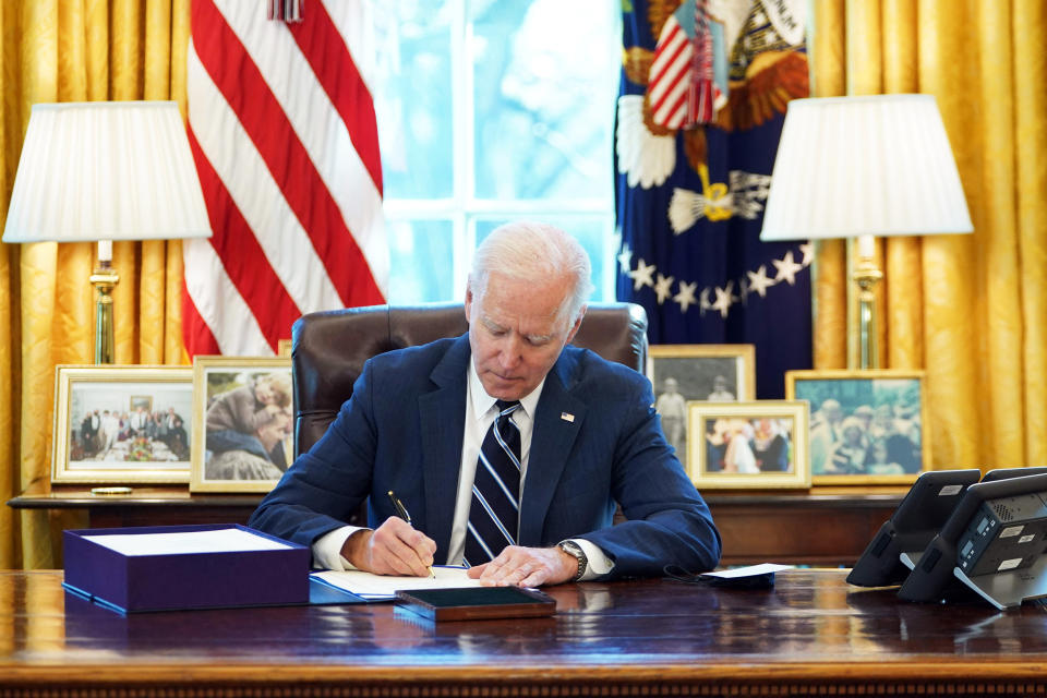 President Joe Biden signs the American Rescue Plan on March 11, 2021, in the Oval Office of the White House. (Mandel Ngan / AFP - Getty Images)