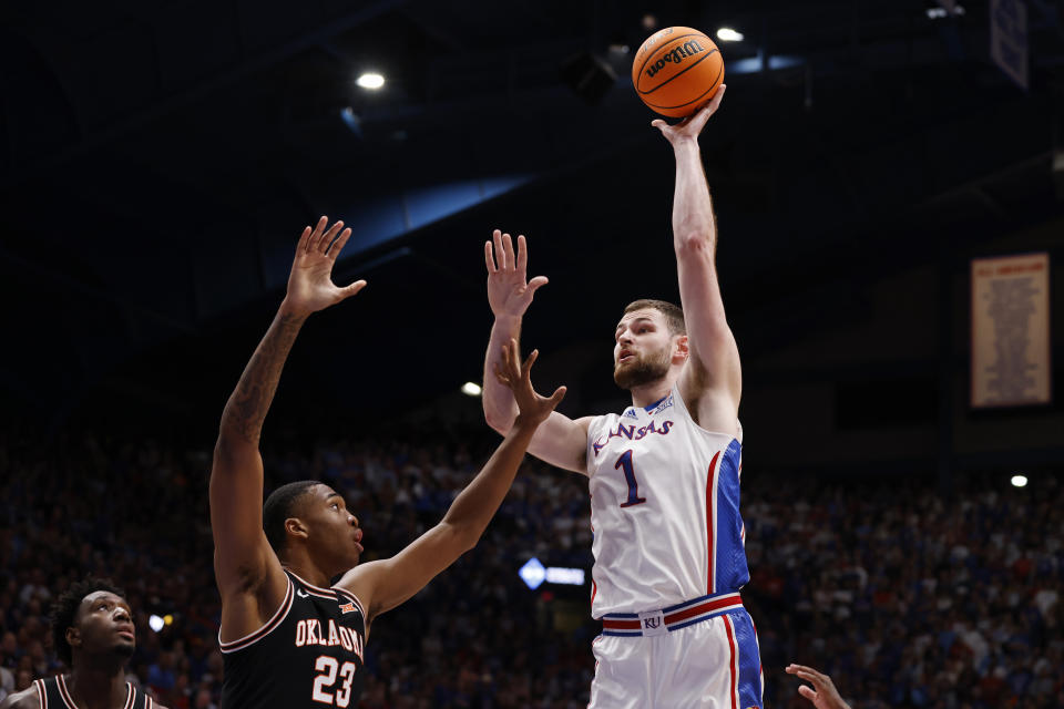 Kansas center Hunter Dickinson (1) attempts to score over Oklahoma State center Brandon Garrison (23) during the first half of an NCAA college basketball game, Tuesday, Jan. 30, 2024, in Lawrence, Kan. (AP Photo/Colin E. Braley)