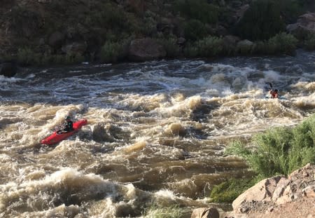 Kayakers in high water on the Rio Grande river south of Pilar, New Mexico