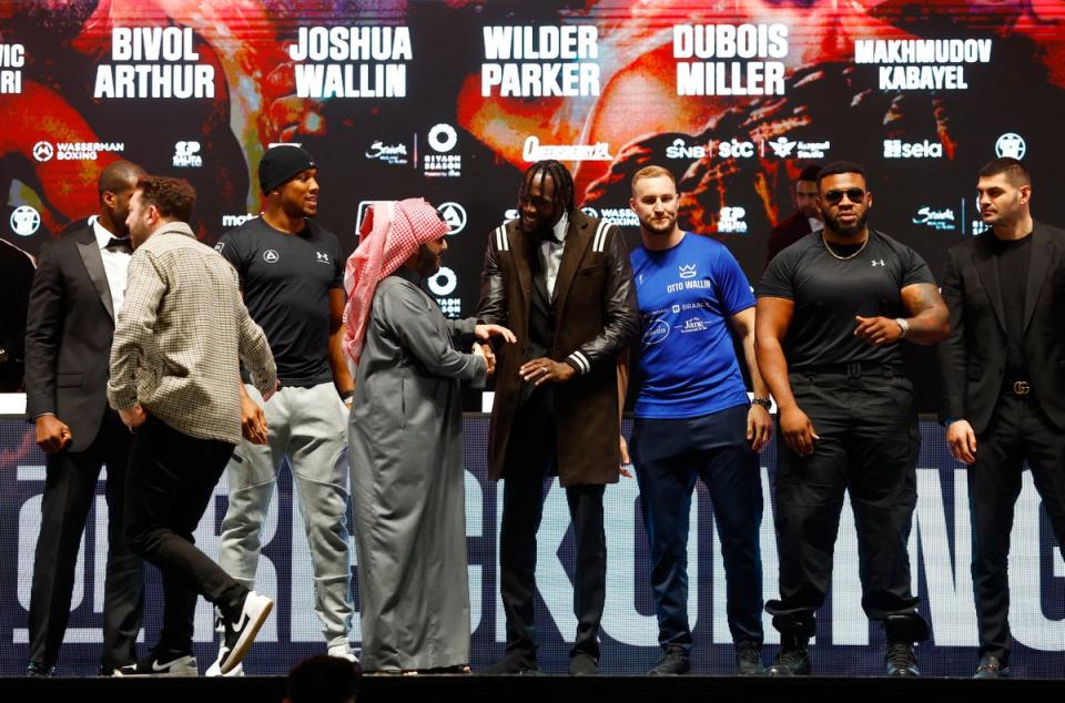Joshua and Wilder are greeted by Saudi adviser Turki Alalshikh, while standing alongside fellow heavyweights (Action Images via Reuters)