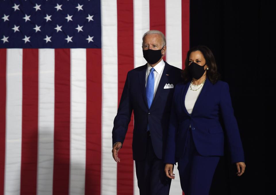 Democratic presidential nominee and former US Vice President Joe Biden (L) and vice presidential running mate, US Senator Kamala Harris, arrive to conduct their first press conference together in Wilmington, Delaware, on August 12, 2020. (Photo by Olivier DOULIERY / AFP)