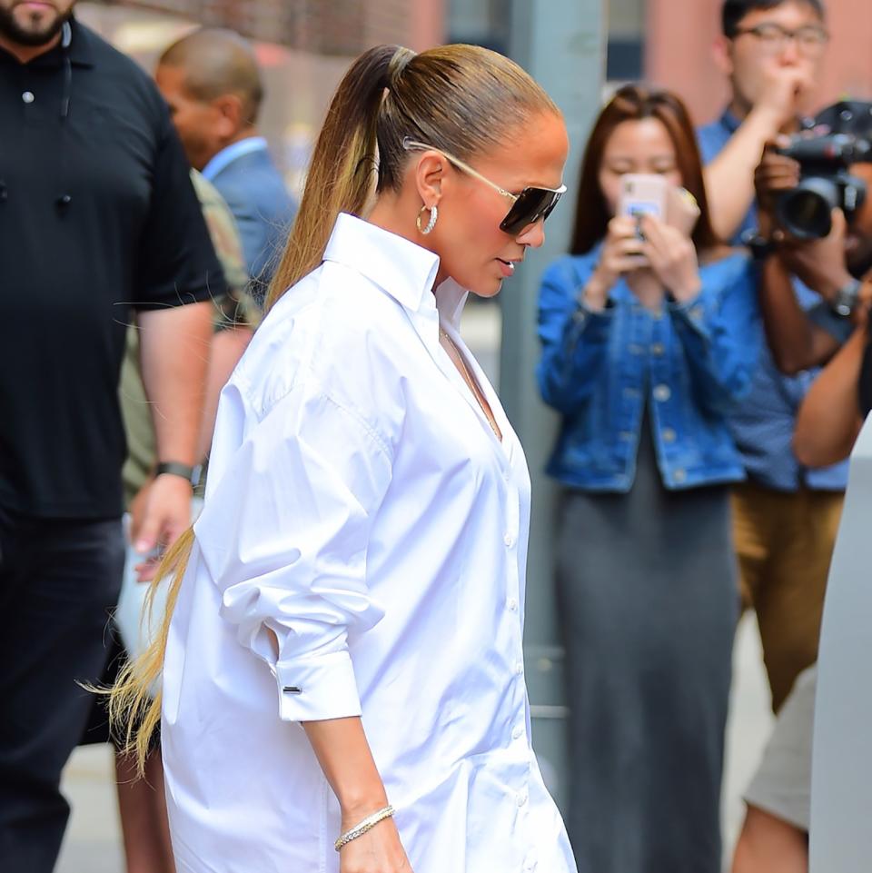 At 49, Jennifer Lopez makes a pair of Versace denim boots look even more glamorous.