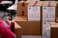 An election worker seals a box of tabulated ballots inside the Maricopa County Recorders Office, Wednesday, Nov. 9, 2022, in Phoenix. (AP Photo/Matt York)