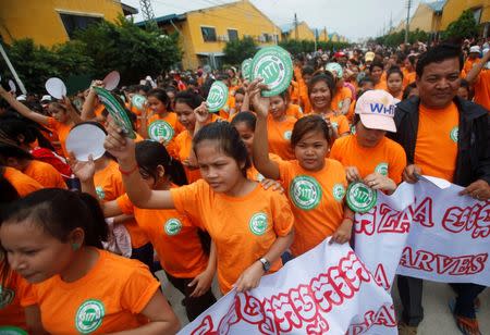Garment workers hold stickers during a protest calling for higher wages in Phnom Penh September 17, 2014. REUTERS/Samrang Pring