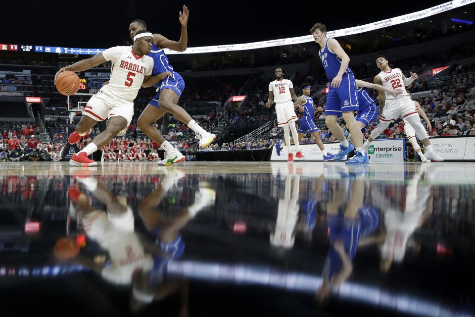 Bradley's Darrell Brown Jr. (5) heads to the basket past Drake's D.J. Wilkins during the first half of an NCAA college basketball game in the semifinal round of the Missouri Valley Conference men's tournament Saturday, March 7, 2020, in St. Louis. (AP Photo/Jeff Roberson)