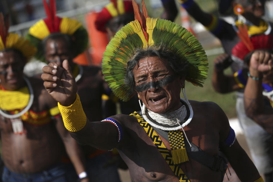 Indigenous people celebrate after a majority of Supreme Court justices ruled to enshrine their land rights in a landmark case in Brasilia, Brazil, Thursday, Sept. 21, 2023. Six of the 11 Supreme Court justices voted against establishing a cut-off date after which Indigenous peoples could not claim new territory. (AP Photo/Gustavo Moreno)