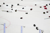 Gloves and sticks litter the rink as Canada celebrates is victory over Germany during the gold medal match at the Ice Hockey World Championship in Tampere, Finland, Sunday, May 28, 2023. Canada won 5-2. (AP Photo/Pavel Golovkin)