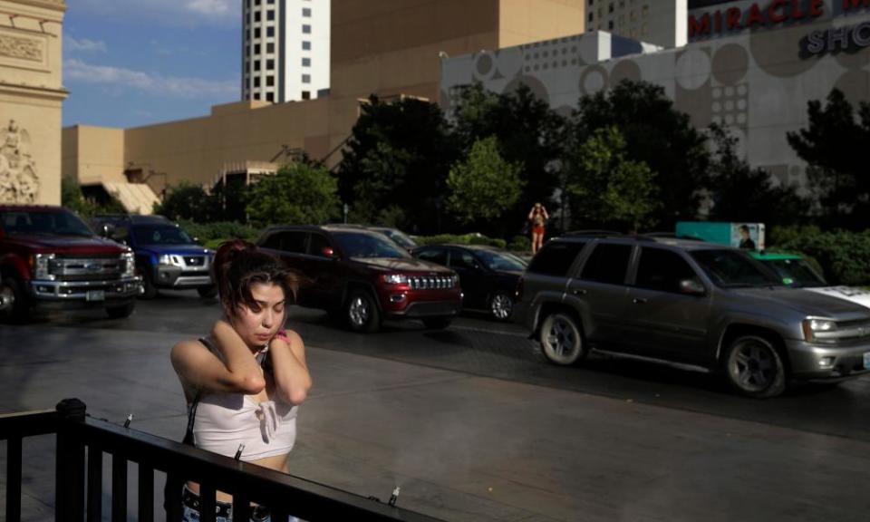 A woman tries to cool off in a mist of water in Las Vegas – the worst urban heat island in the US.