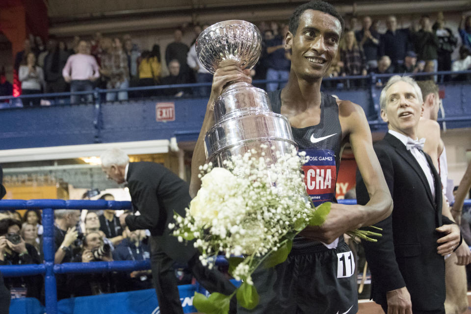 Yomif Kejelcha, of Ethiopia holds his trophy after winning the men's Wanamaker Mile at the Millrose Games track and field meet, Saturday, Feb. 9, 2019, in New York. (AP Photo/Mary Altaffer)