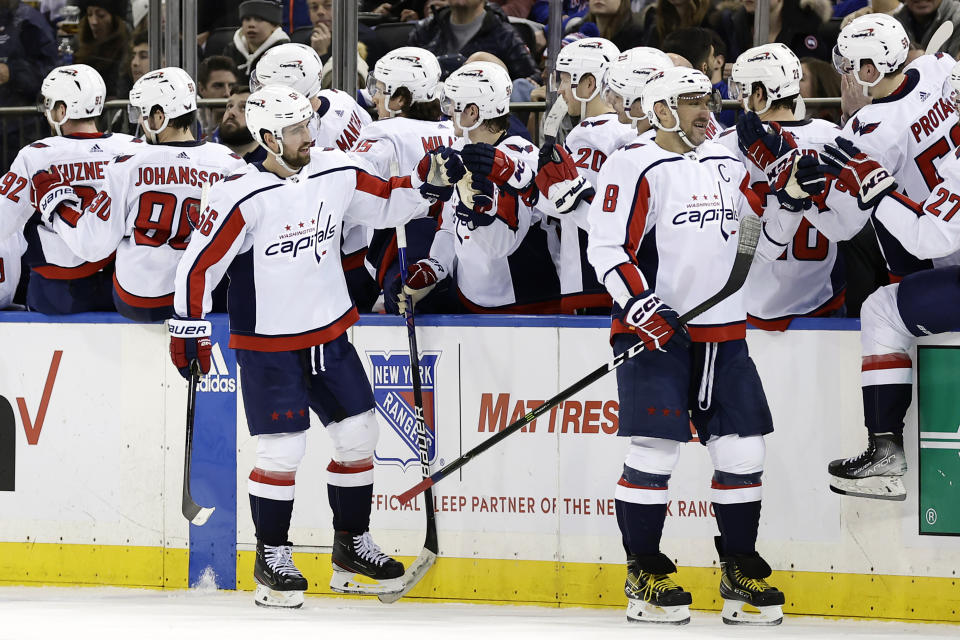 Washington Capitals defenseman Erik Gustafsson (56) celebrates with teammates after scoring a goal against the New York Rangers during the second period of an NHL hockey game Tuesday, Dec. 27, 2022, in New York. (AP Photo/Adam Hunger)
