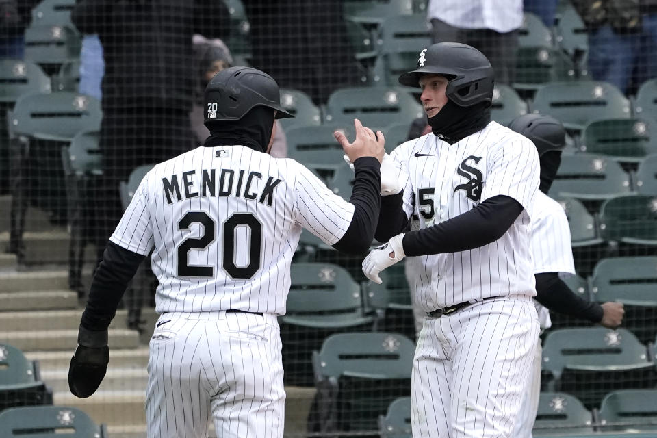 Chicago White Sox's Andrew Vaughn (25) celebrates his three-run home run off Kansas City Royals relief pitcher Scott Barlow with Danny Mendick during the seventh inning of a baseball game Wednesday, April 27, 2022, in Chicago. (AP Photo/Charles Rex Arbogast)