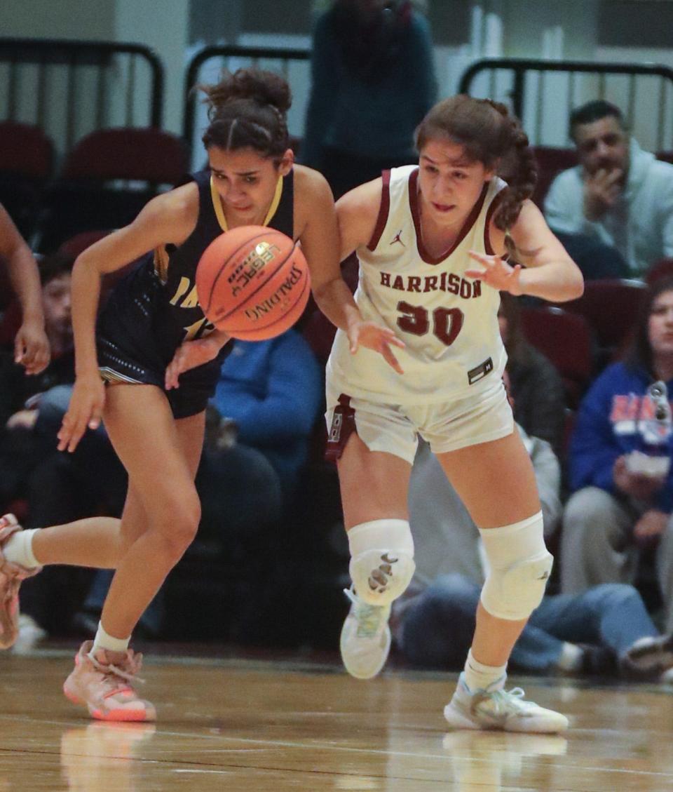 Sofia Tavares of Walter Panas and Olivia Fernandez of Harrison battle for a loose ball during the Section 1 Class A Girls Basketball championship at the Westchester County Center March 5, 2023. Panas defeated Harrison 50-47.