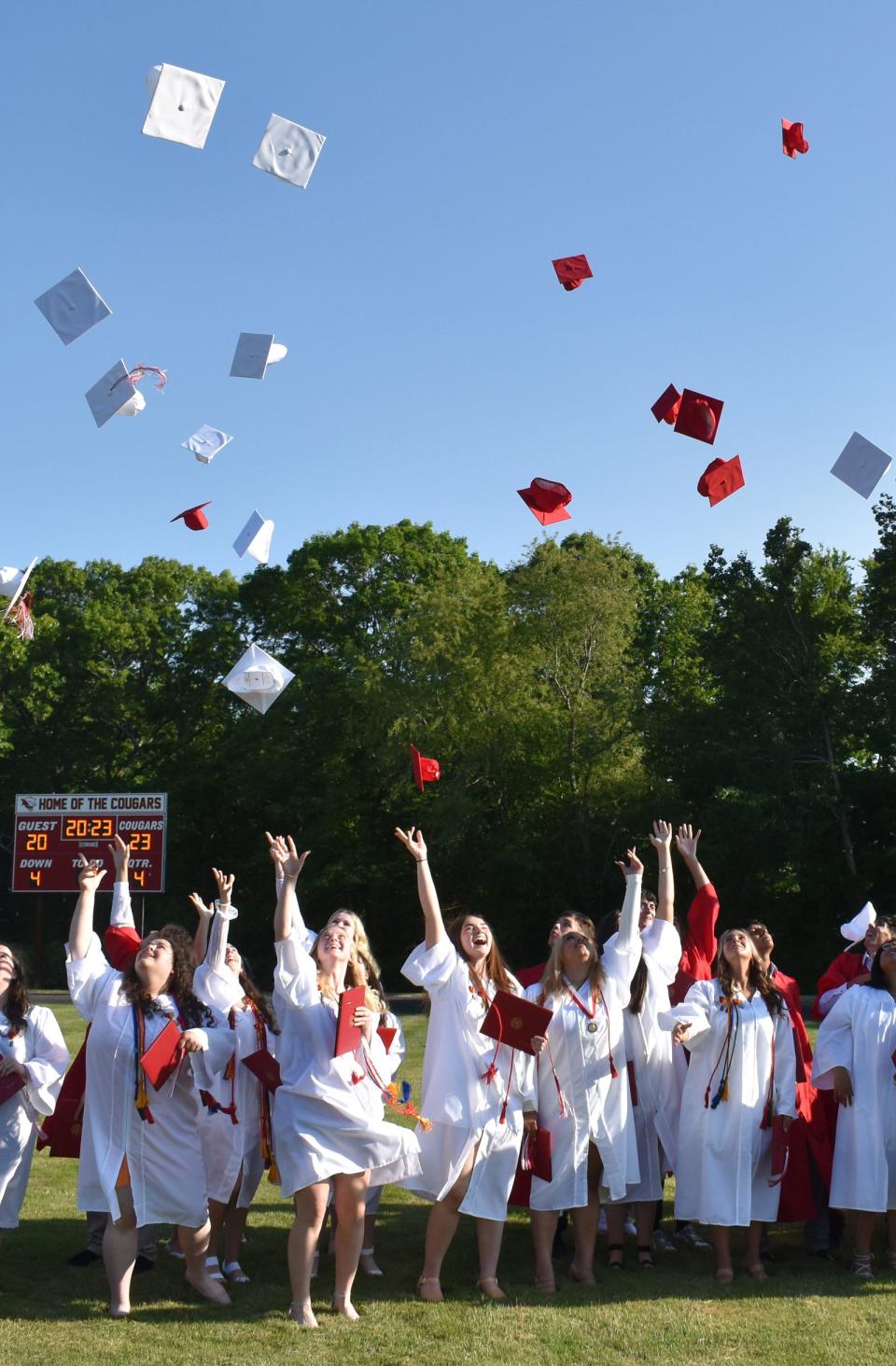 Bishop Connolly High School graduates toss their caps into the air after the 54th commencement ceremony on Wednesday, May 31, 2023.