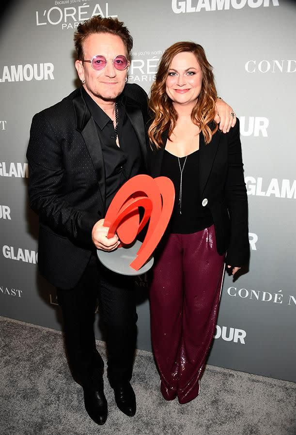 Bono with Amy Poehler at the Glamour awards. Photo: Getty Images.