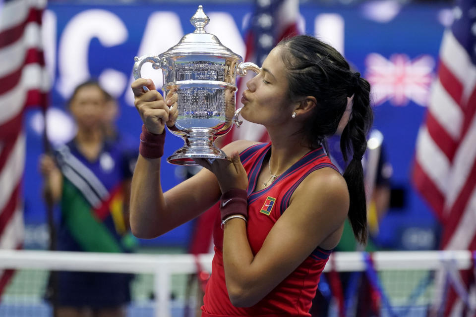 Emma Raducanu, of Britain, kisses the US Open championship trophy after defeating Leylah Fernandez, of Canada, during the women's singles final of the US Open tennis championships, Saturday, Sept. 11, 2021, in New York. (AP Photo/Seth Wenig)