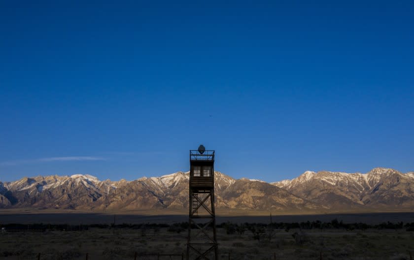 MANZANAR, CA - MAY 07: The rising sun illuminates the Sierra Nevada crest behind a restored guard tower at the Manzanar National Historic Site, a former 814-acre Japanese internment camp on Thursday, May 7, 2020 in Manzanar, CA. (Brian van der Brug / Los Angeles Times)