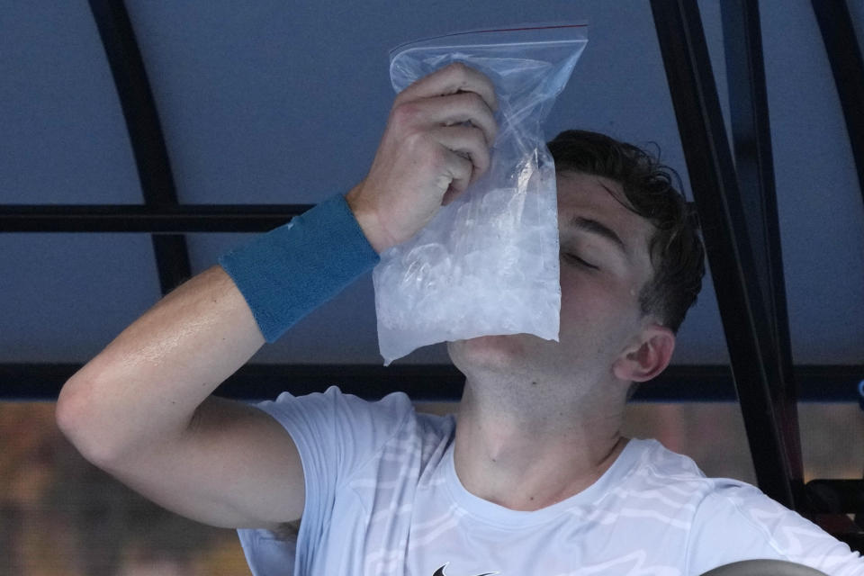 Jack Draper of Britain places a bag of ice on his face during his first round match against Rafael Nadal of Spain at the Australian Open tennis championship in Melbourne, Australia, Monday, Jan. 16, 2023. (AP Photo/Aaron Favila)