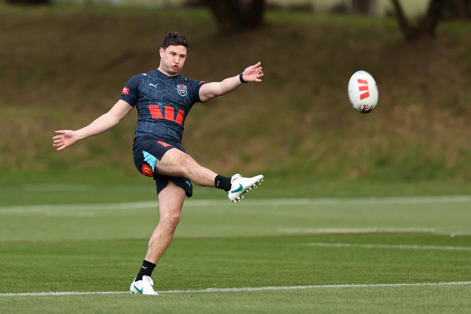 Mitchell Moses kicks the ball.