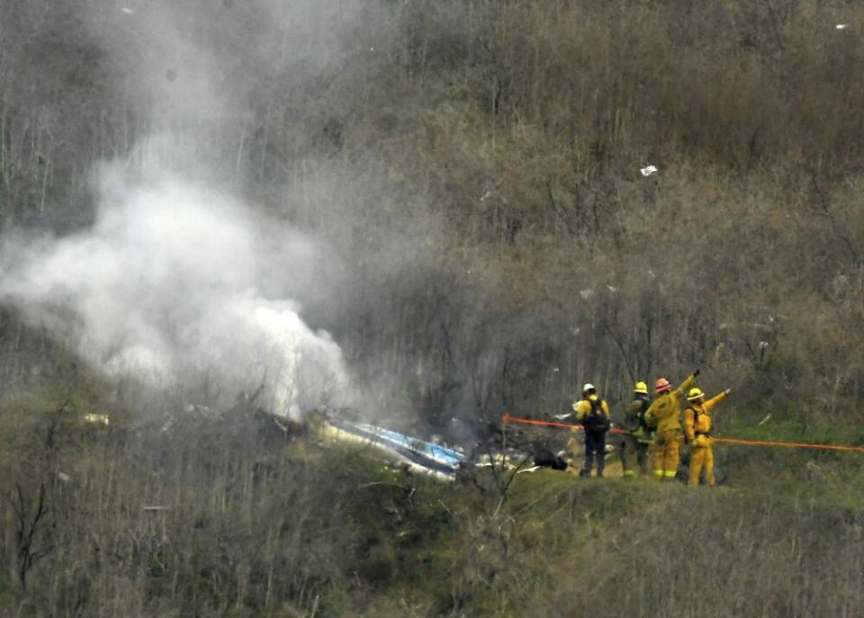 Firefighters working at the scene of the helicopter crash | Shutterstock