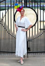 Model Jodie Kidd wearing a six-tier hat by Ladbrokes with a white, belted dress. <em>[Photo: PA]</em>