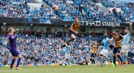 Britain Soccer Football - Manchester City v Arsenal - Barclays Premier League - Etihad Stadium - 8/5/16 Arsenal's Laurent Koscielny heads against the crossbar however is later give offside Action Images via Reuters / Jason Cairnduff Livepic EDITORIAL USE ONLY.