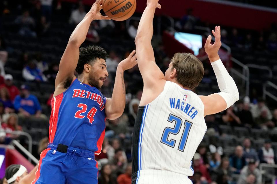 Detroit Pistons guard Quentin Grimes (24) passes the ball as Orlando Magic center Moritz Wagner (21) defends at Little Caesars Arena in Detroit on Saturday, Feb. 24, 2024.