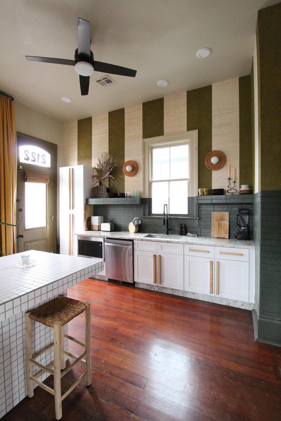 Kitchen with white tiled table by Liz Kamarul